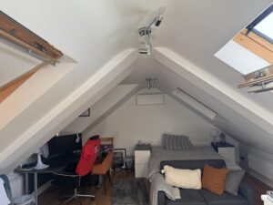 Wall-mounted air conditioning unit in a Chelsea loft conversion bedroom