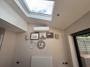 Wall-mounted air conditioning unit in a skylit living space in Kensington